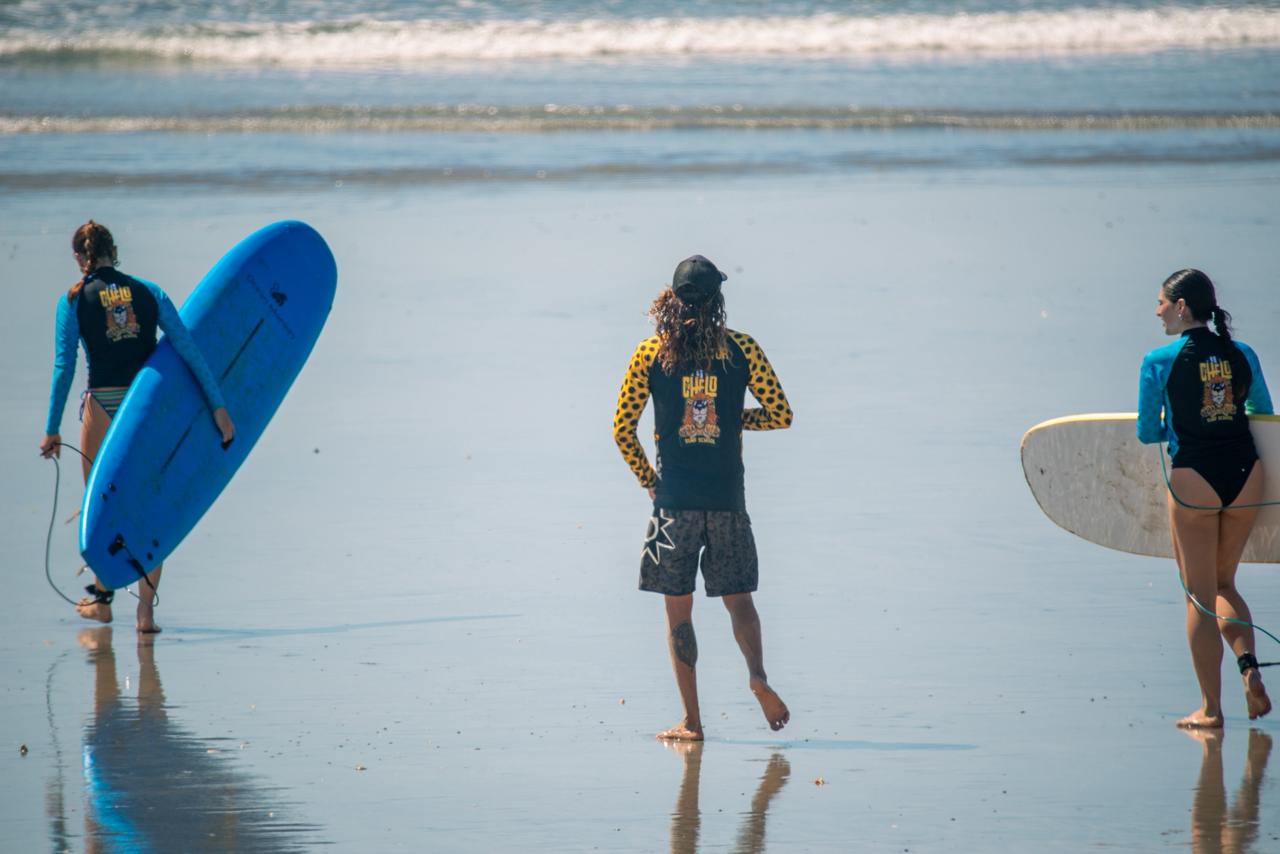 Students walking to the water with Chelo Surf School boards